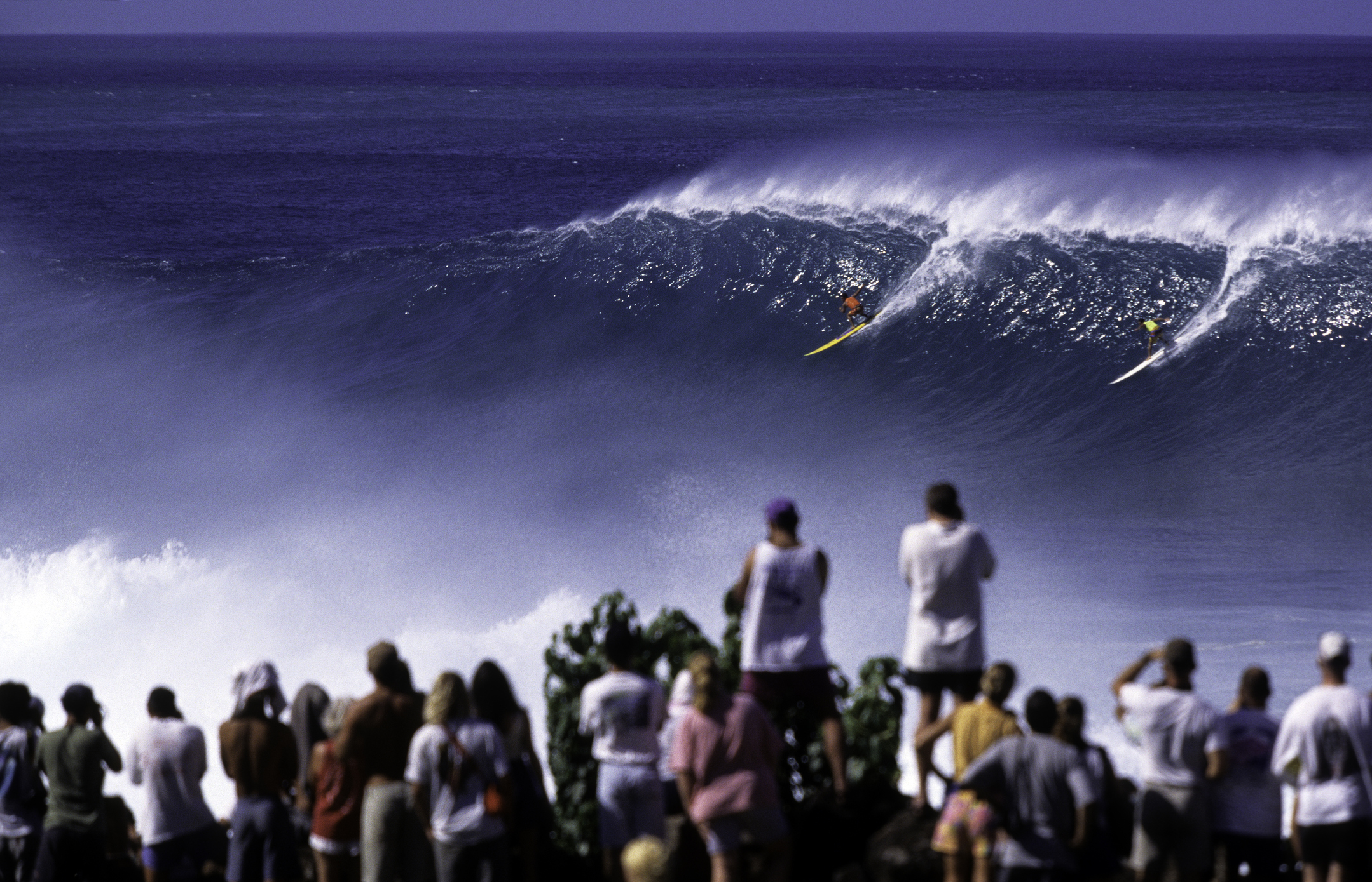 Sharing at Waimea Bay is easy when the wave spans the area of a footy oval. Source: iStock / tropicalpixsingapore