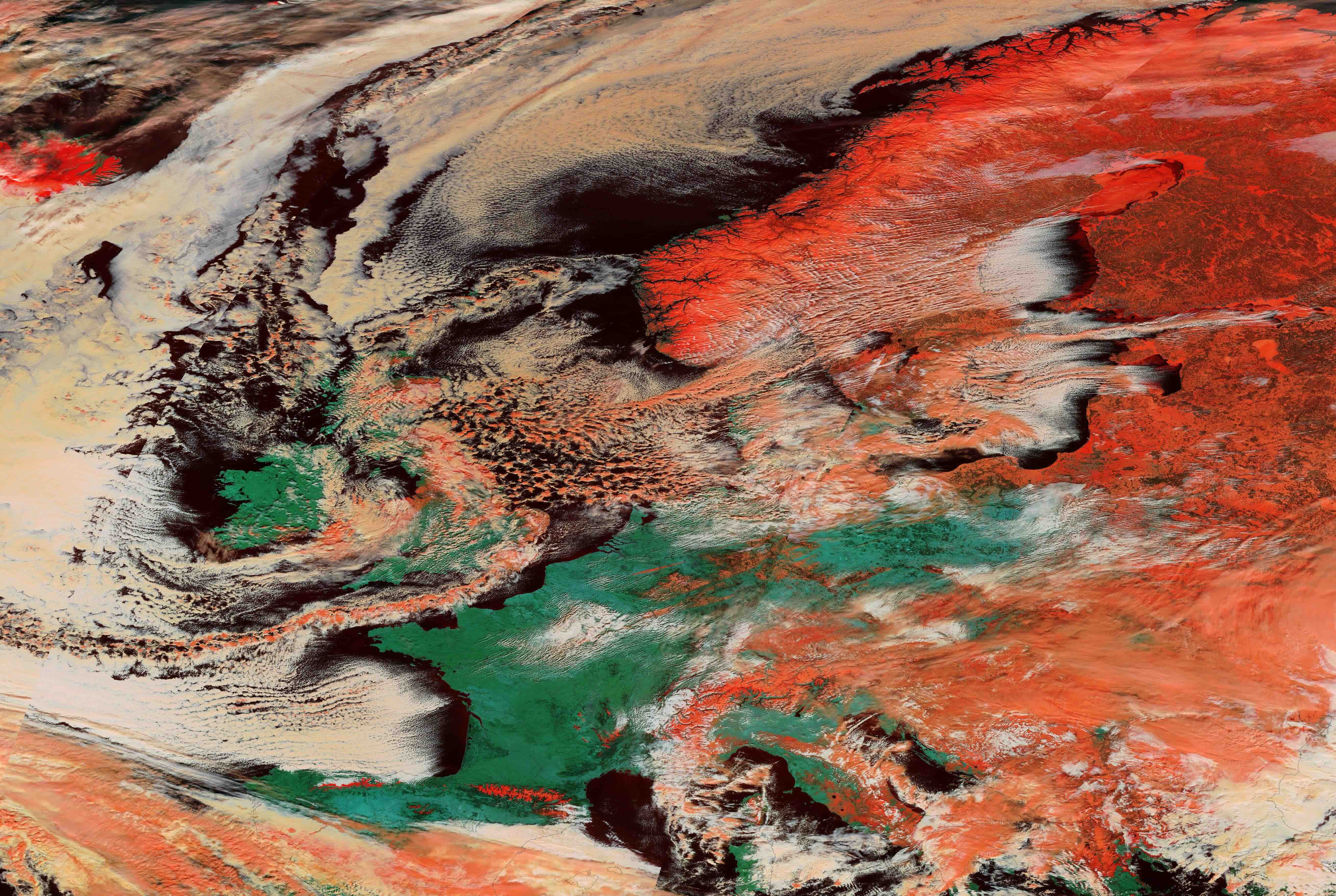 False-colour satellite image showing snow and ice (red) over parts of the UK and Europe on February 27, 2018. Source: NASA Worldview.